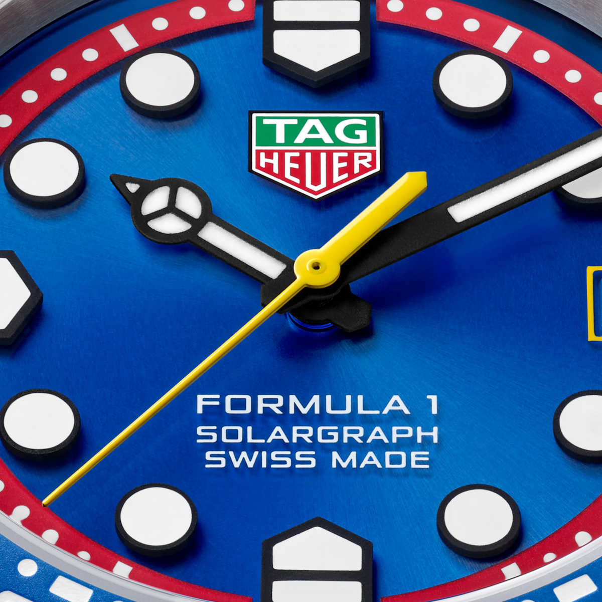 Housed within a robust 38mm sand-blasted stainless steel case, the watch features a striking blue sunray-brushed dial accented by a vibrant red flange and contrasting yellow central seconds han