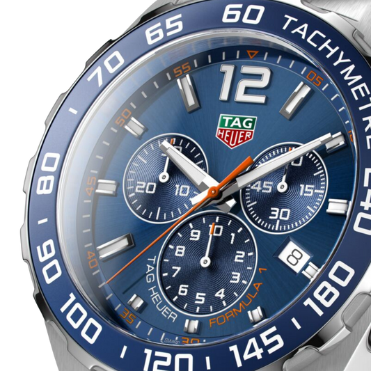 close-up of the blue dial highlighting the tri-compax chronograph layout, orange detailing on the hands and markers, and high-contrast sub-dials for precise readability