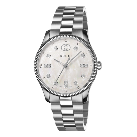 Gucci stainless steel watch with a mother-of-pearl dial, diamond hour markers, and fluted bezel shown in full front view
