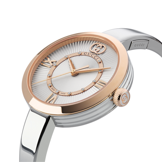 Gucci Model 2000 30mm Swiss Made quartz watch featuring a silver dial, sculptural steel bangle and pink gold-tone bezel