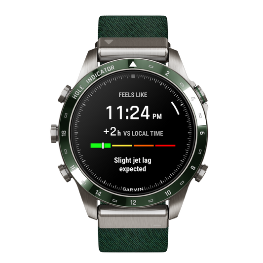Garmin MARQ Adventurer Gen 2 smartwatch with AMOLED touchscreen display, green compass bezel, titanium case, and green woven strap featuring the jet lag adviser interface
