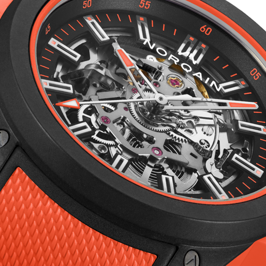 Close-up of the Norqain skeleton dial sports watch showcasing exposed mechanical components, orange accents, black case construction and a bold adventure-inspired design.