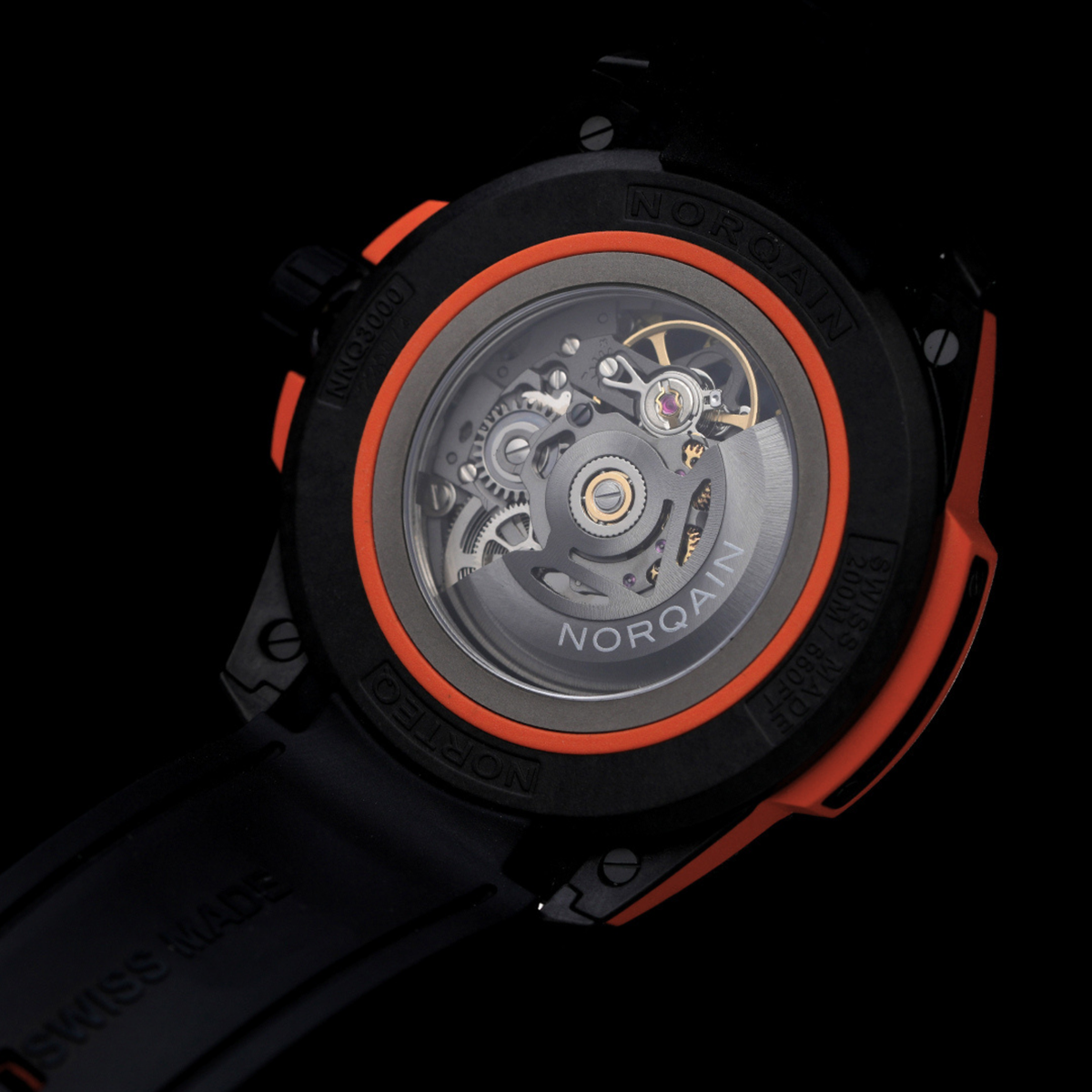 Close-up of a watch with visible mechanical components and 'NORQAIN' branding on a black background.