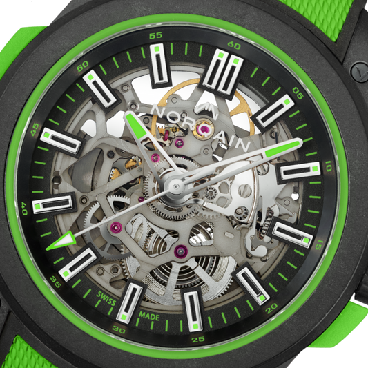 Detailed view of the Norqain Independence Skeleton Automatic with a transparent dial, visible gears and balance wheel, bold green highlights and a durable textured rubber strap.