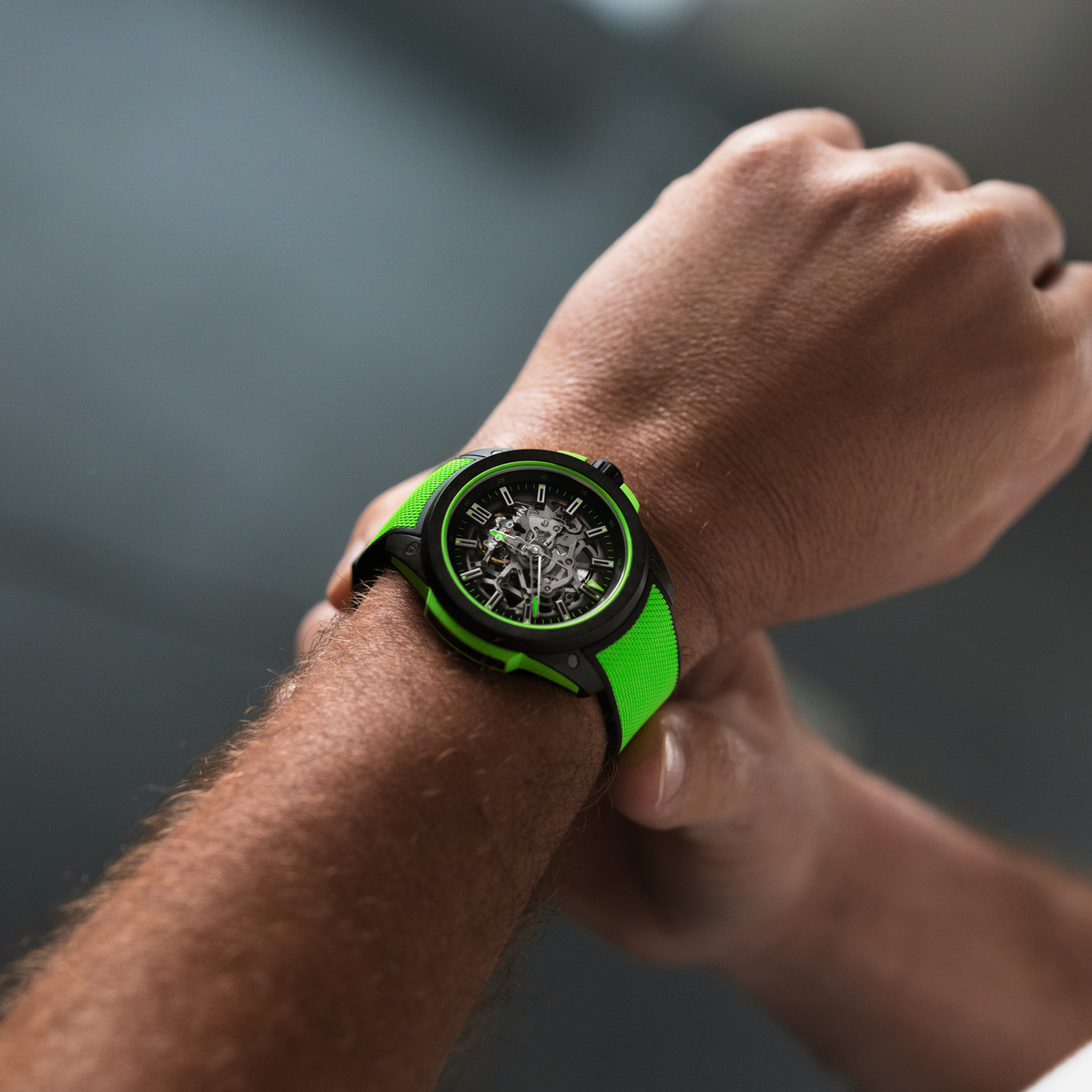 Close-up of the Norqain skeleton dial sports watch showcasing exposed mechanical components, bright green accents, black performance case and modern adventure-ready styling.