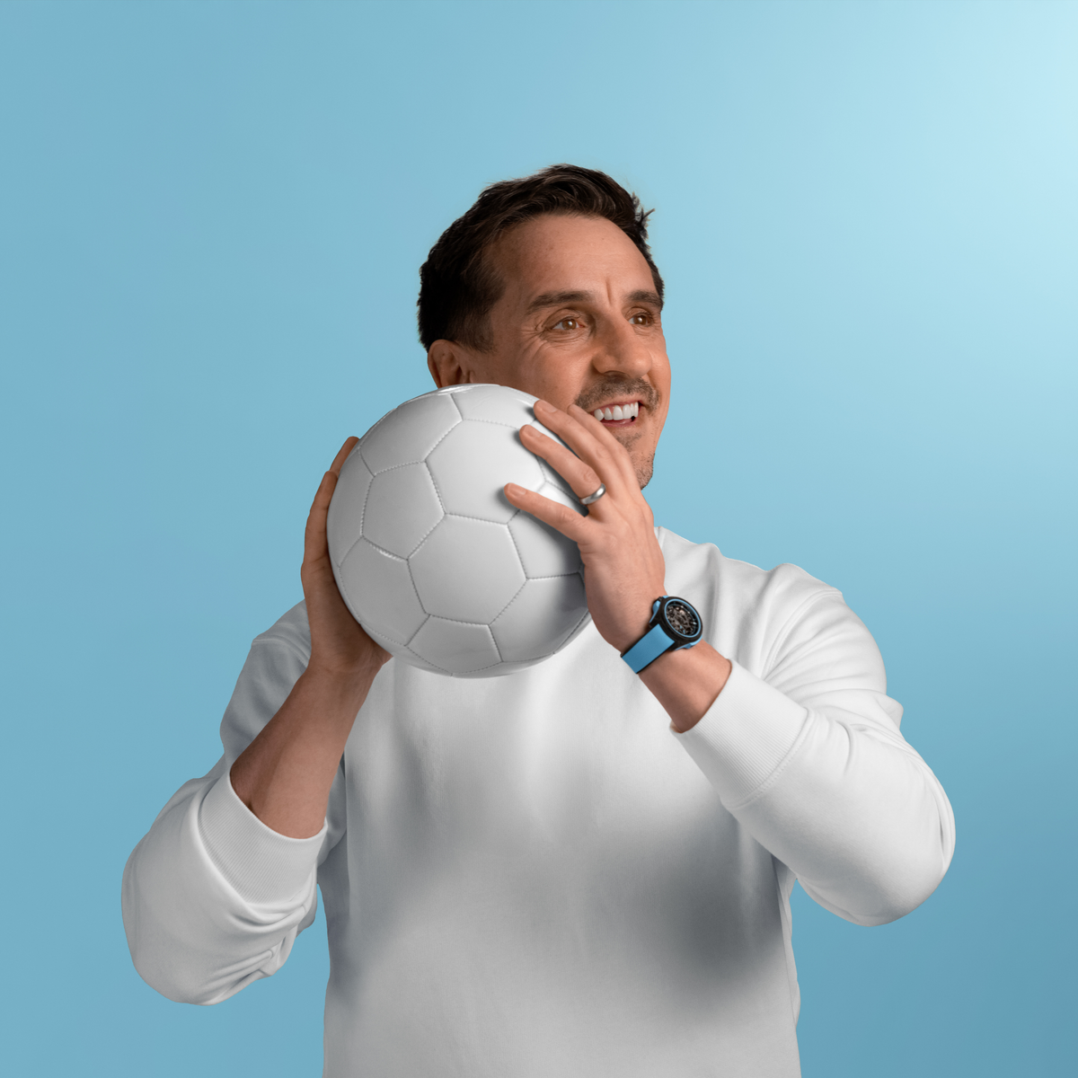 gary neville footballer norqain watch.  Detailed view of the Norqain skeleton sports watch featuring sky blue accents
