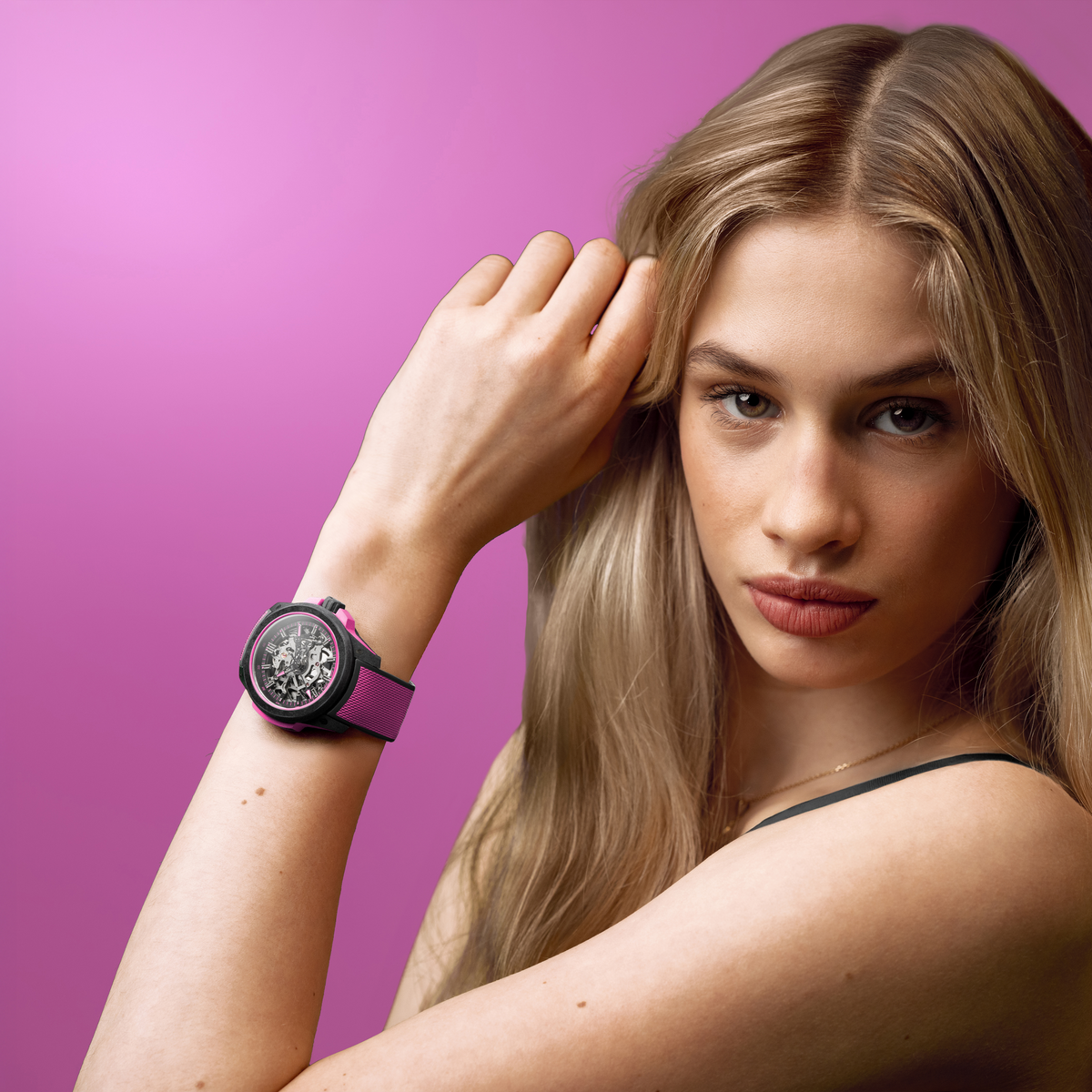 Luxury Norqain Independence Skeleton Automatic watch showcasing a transparent dial, visible gears and movement components, paired with a striking pink rubber strap and black case.