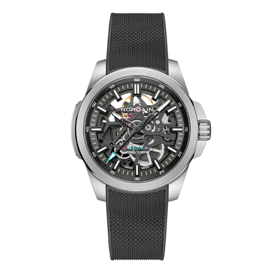Front view of the Norqain Independence Skeleton Chronograph Watch featuring a black open-worked dial, visible mechanical movement, rose gold-tone accents and a black textured rubber strap.