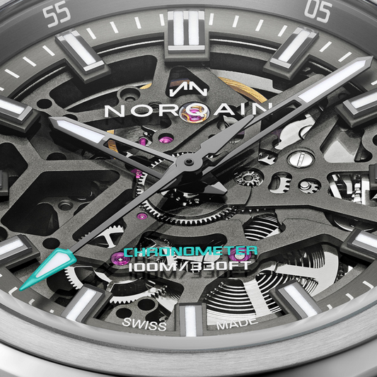 Close-up of the Norqain automatic skeleton chronograph showcasing exposed gears, twin chronograph sub-dials, luminous rose gold-tone hands and a brushed stainless steel case.