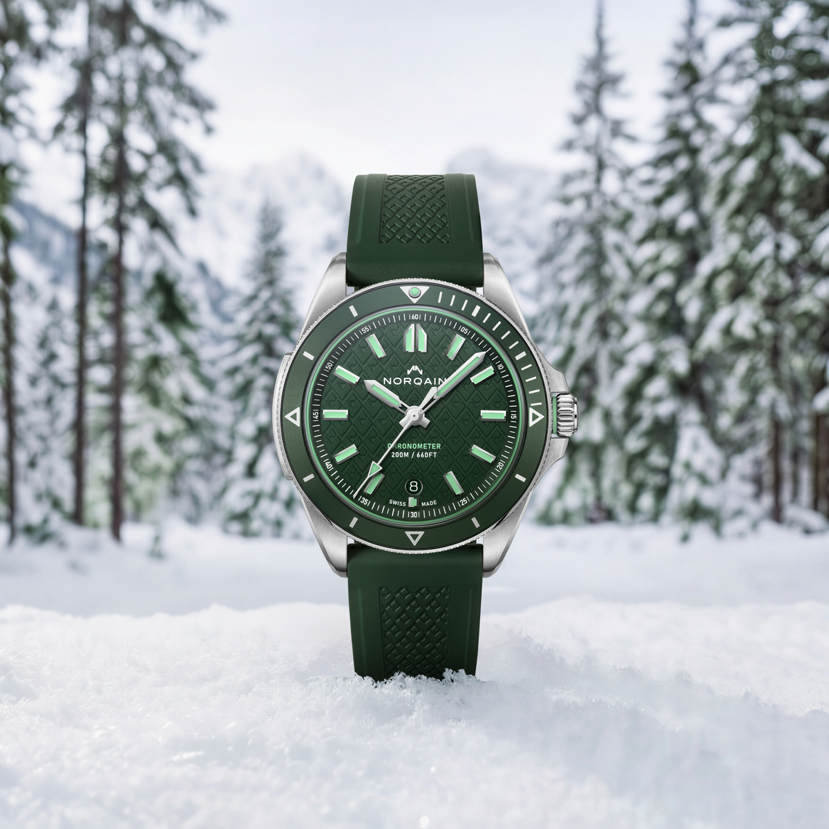 Close-up detail of the Norqain Adventure Sport 42mm Stainless Steel Watch featuring the textured green dial, Super-LumiNova-filled hands and markers, chronometer certification and premium finishing.
