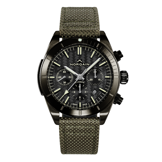 Front view of the Norqain Adventure Sport Chronograph Black Dial Watch featuring a textured black dial, three chronograph sub-dials, black DLC-coated case and durable khaki fabric strap.