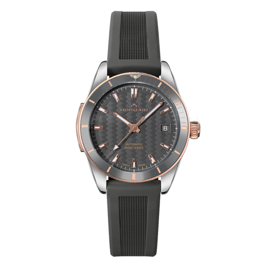 Front view of the Norqain Independence Grey Dial Watch featuring a textured grey dial, rose gold-tone accents, black rubber strap, date window and automatic Swiss movement.