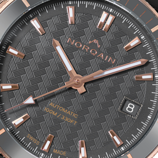 Close-up detail of the Norqain Independence Grey Dial Automatic Watch featuring the signature geometric dial texture, rose gold-tone detailing, date display at 3 o’clock and premium Swiss-made craftsmanship.
