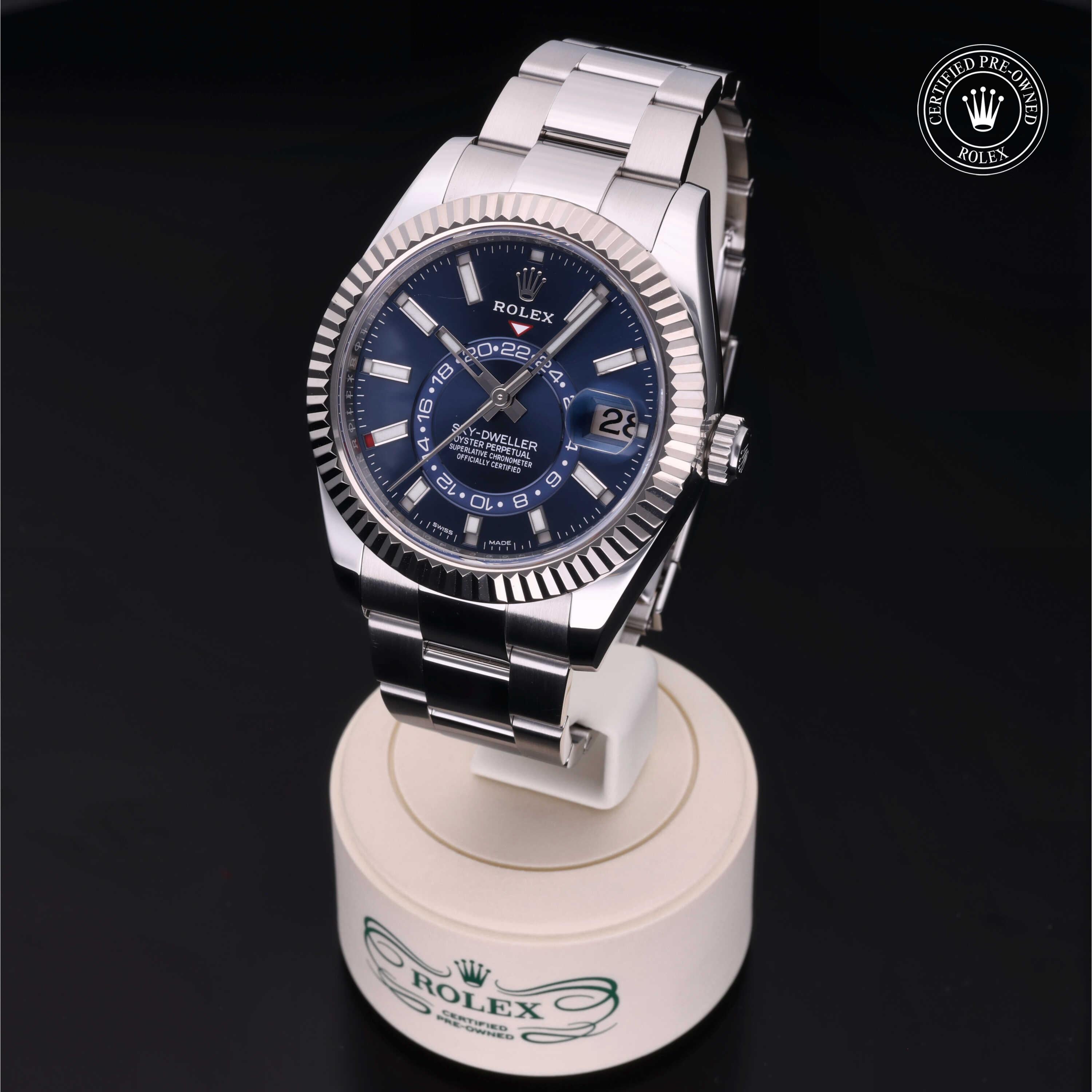 Rolex Sky-Dweller 42mm 2021 model featuring a vibrant blue dial with baton hour markers, rotatable fluted bezel and elegant Oystersteel construction.