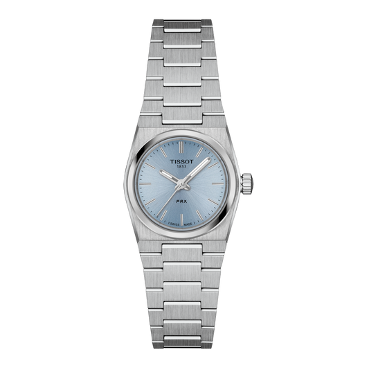 Tissot PRX stainless steel watch featuring a light blue sunburst dial, slim baton hour markers, and a sleek integrated case and bracelet design for a clean, modern look