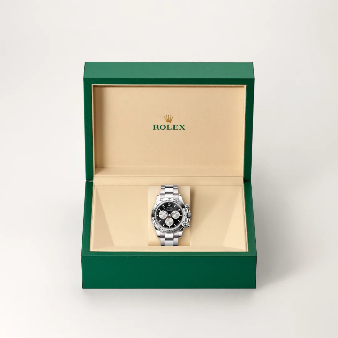 Rolex Cosmograph Daytona in 18 ct white gold with a Bright black and steel dial, Fixed, with engraved tachymetric scale, in 18 ct white gold bezel, Oyster, three-piece solid links bracelet